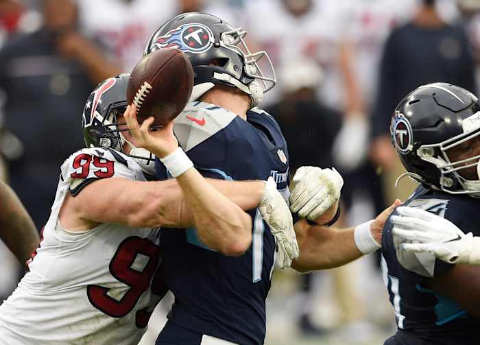 Houston Texans defensive end J.J. Watt (99) forces Tennessee Titans quarterback Ryan Tannehill to fumble.